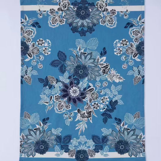 Floral patterned fabric with blue and white flowers on a blue background
