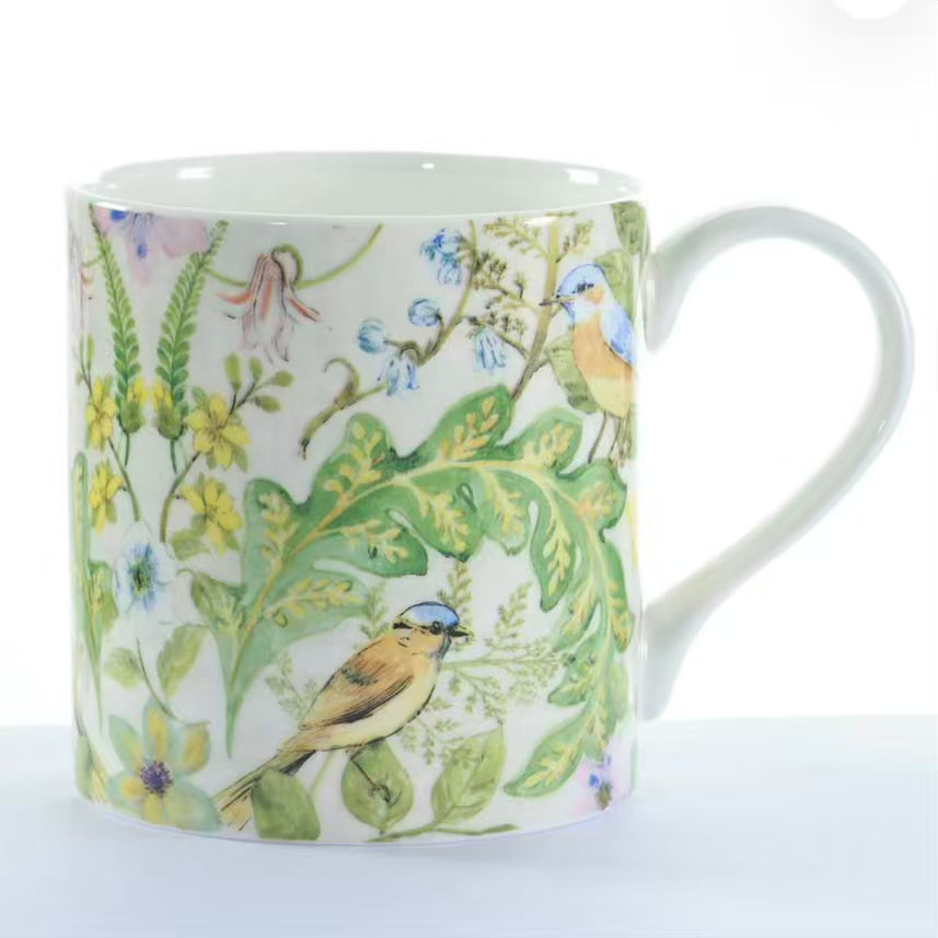 Mug with bird and floral design on a white background