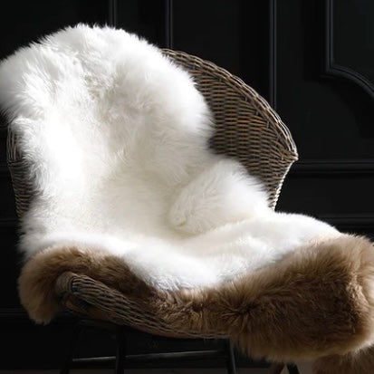 2 sheepskin throws draped on a wicker chair
