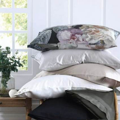 Stack of pillows with floral design, Floz, on top, against a light background