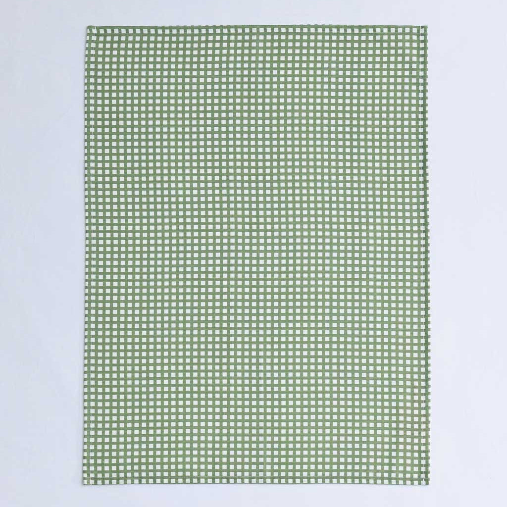 A rectangular green and white gingham checkered fabric item, likely a tea towel or small blanket, laid flat against a light gray background.
