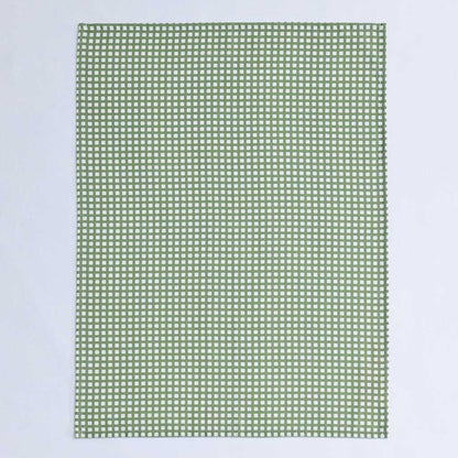 A rectangular green and white gingham checkered fabric item, likely a tea towel or small blanket, laid flat against a light gray background.