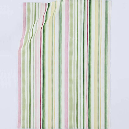 A rectangular textile item, likely a towel or blanket, featuring a vertical striped pattern in soft pastel shades of green, pink, yellow, and white, laid flat against a light gray background.