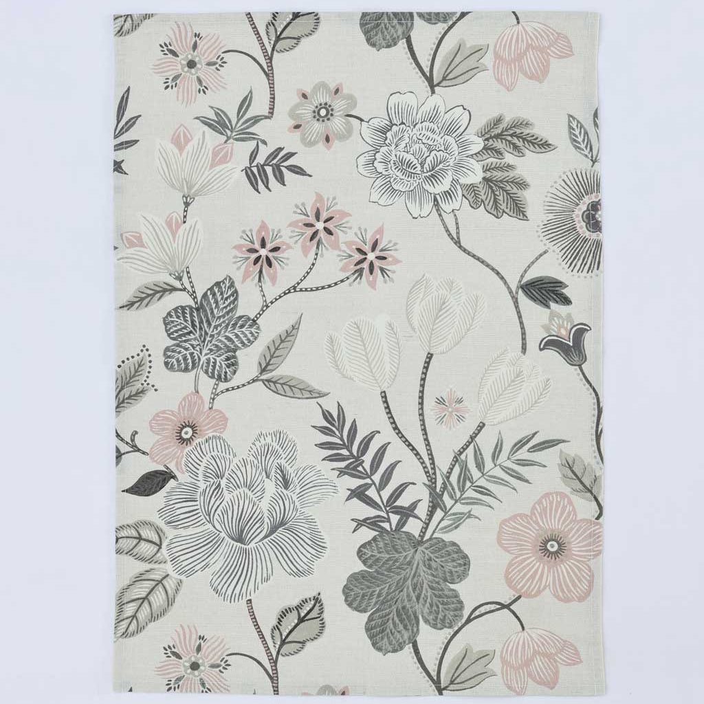 A rectangular area rug with a botanical floral pattern featuring gray, white, and soft pink flowers with green leaves on an off-white background, shown flat against a light gray backdrop.