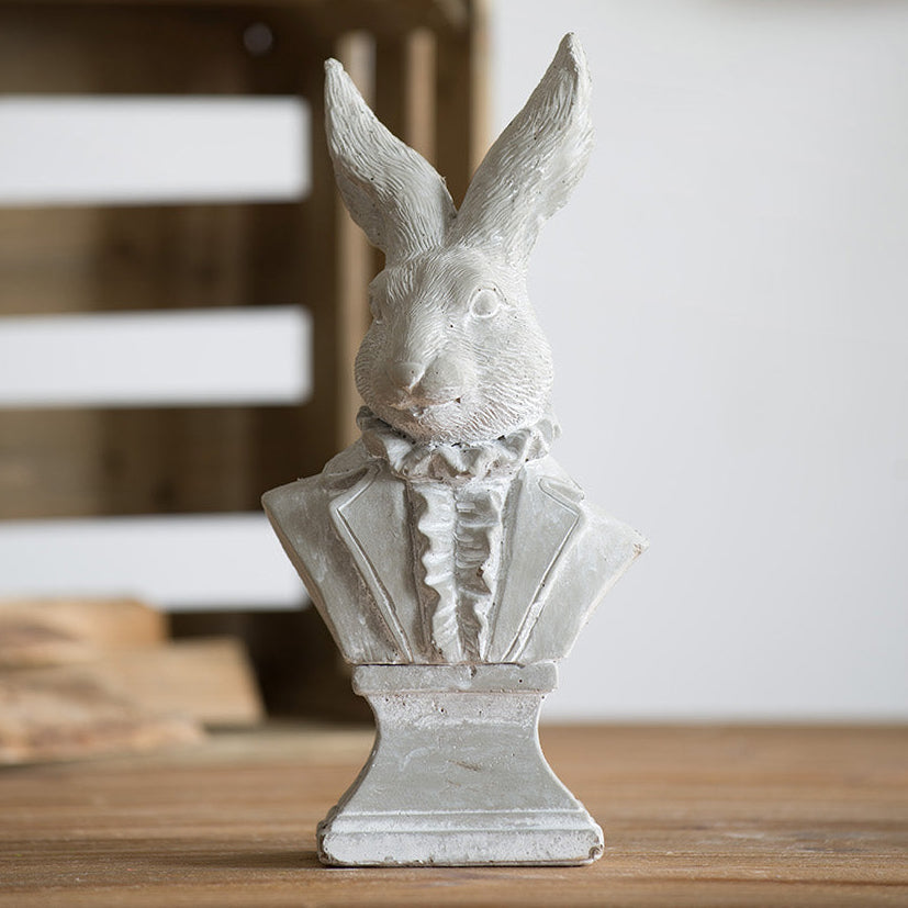 Decorative rabbit sculpture on a wooden surface with a blurred background