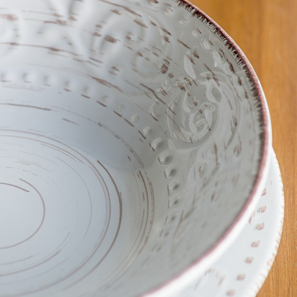 Close-up of a ceramic bowl with textured design on a wooden surface