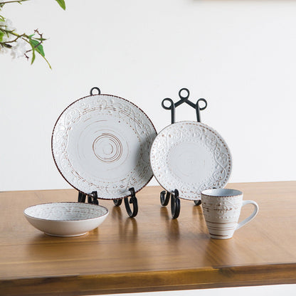 Ceramic tableware set on a wooden surface with a white background
