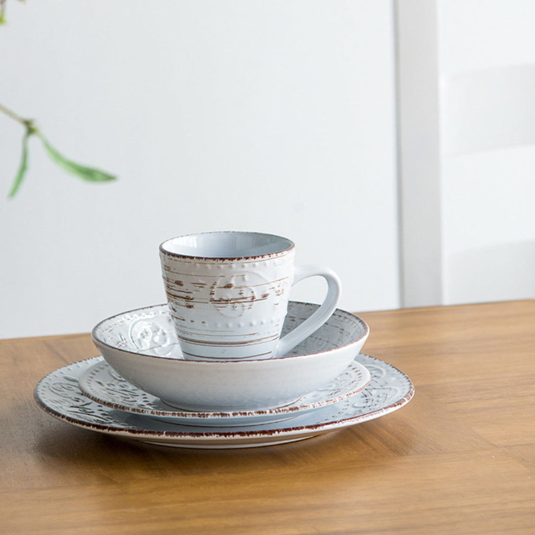 Ceramic tableware set on a wooden table with a white background