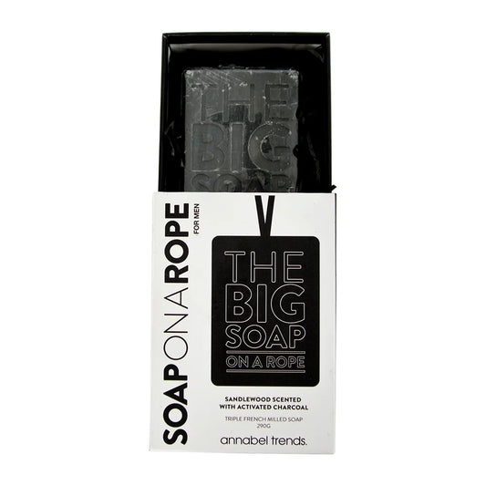 Black soap bar on a rope with packaging displaying brand name and product details.