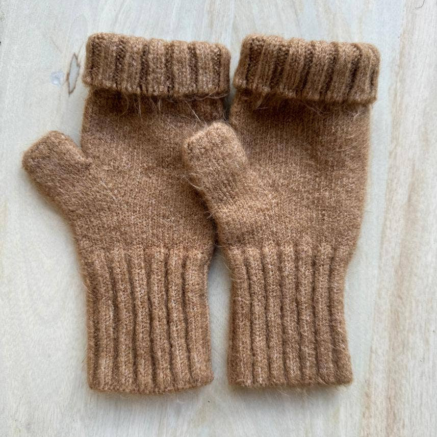 Pair of brown knit fingerless gloves on a light wooden surface