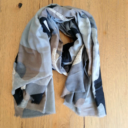 Scarf with geometric pattern on a wooden surface
