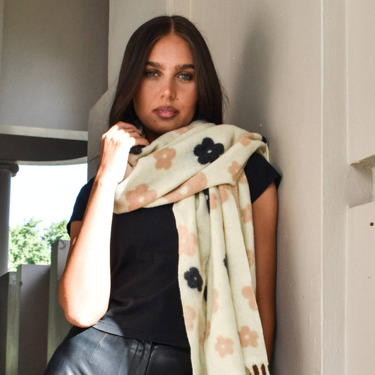 Woman wearing a floral scarf in an indoor setting
